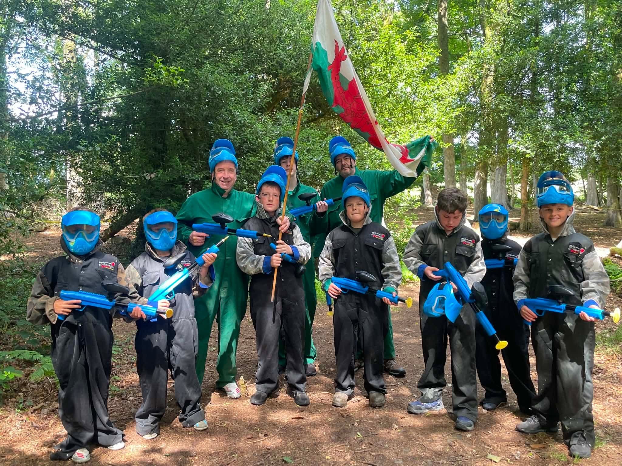 Kids paintball game with flag in the woods