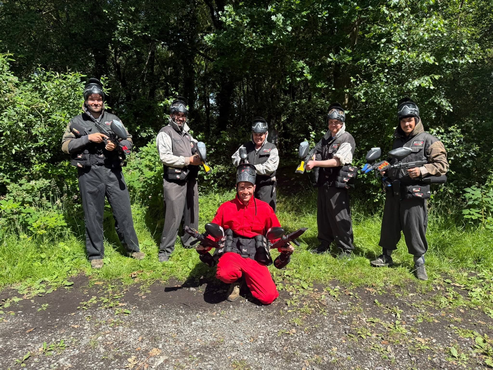 Stag do players lined up before a game in the woodland