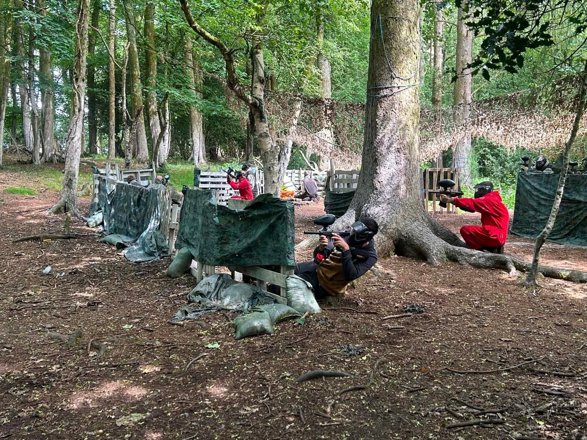 Paintball players in position in the Snowdonia woodland arena